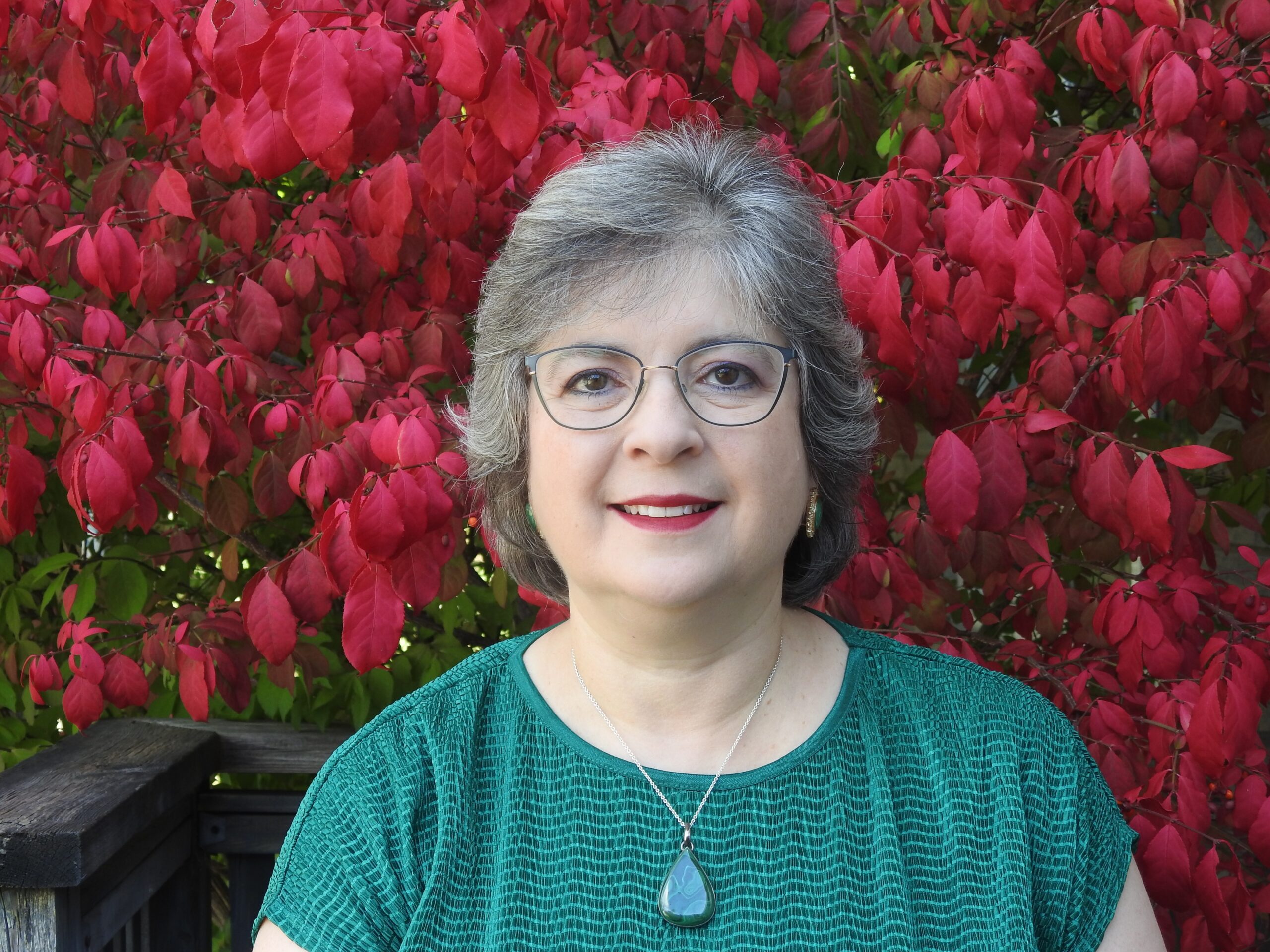 Christine Lennips profile picture - green shirt with red leaves background